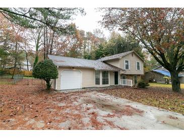 Two-story house with attached garage and large yard at 5734 Dorian Ct, Lithonia, GA 30058