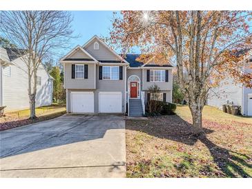 Two-story house with a two-car garage and a landscaped yard at 6576 Snowbird Ln, Douglasville, GA 30134