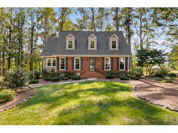 Brick house with gray roof, landscaping, and walkway at 730 Melanie Ct, Canton, GA 30115