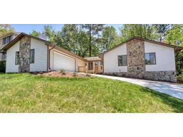 Ranch home with stone accents and a landscaped yard at 9171 Eves Cir, Roswell, GA 30076