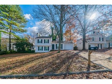 Charming two-story home with a driveway, mailbox, and trees at 4635 Garden Hills Dr, Stone Mountain, GA 30083