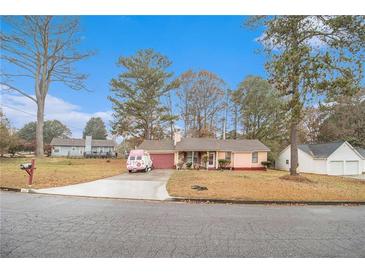 Ranch style house with pink exterior and attached garage at 10359 Briarbay Loop, Jonesboro, GA 30238