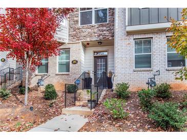 Inviting brick front exterior with steps leading to the entrance and landscaping at 967 Allegro Park, Marietta, GA 30067