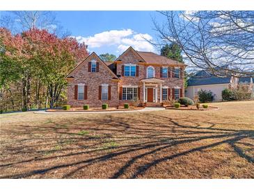 Brick two-story house with a large front yard and mature trees at 4125 Crowder Nw Dr, Kennesaw, GA 30152