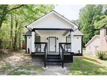 Charming white cottage with black accents and a welcoming front porch at 406 Illinois Nw Ave, Atlanta, GA 30314