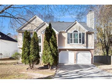 Two-story house with a two-car garage and landscaping at 1488 Bellemeade Farms Sw Rd, Marietta, GA 30008