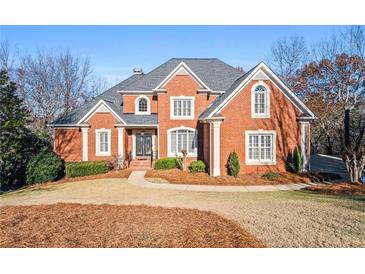 Brick home with a gray roof, front yard, and walkway at 745 Woodscape Trl, Alpharetta, GA 30022