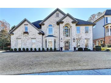 Two-story brick home with manicured lawn at 3350 Vista Creek Dr, Dacula, GA 30019