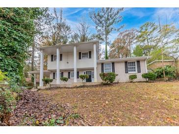 Brick house with covered entry and manicured landscaping at 3390 Glenview Sw Cir, Atlanta, GA 30331