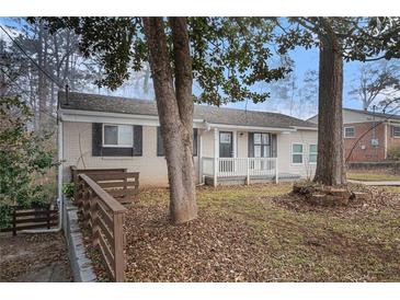 Updated ranch home with a landscaped yard and driveway at 6979 Bruce Cir, Lithonia, GA 30058