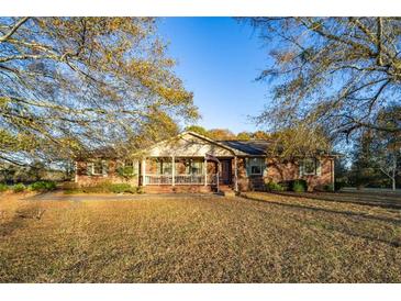 Brick ranch house with a porch and large yard at 1526 N Cherokee N Rd, Social Circle, GA 30025