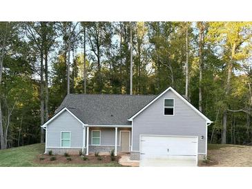 Gray house with white garage door and landscaping; nestled among trees at 18 Garmon Rd, Hiram, GA 30141