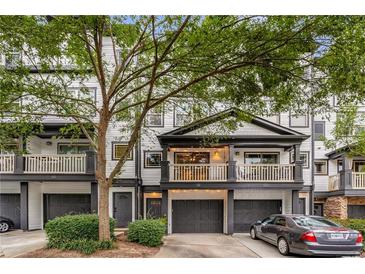 Charming townhome with a balcony, attached garage, and inviting front porch at 216 Semel Nw Dr # 376, Atlanta, GA 30309