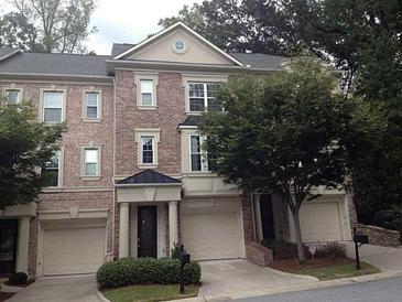 Brick three-story townhome with two-car garage and landscaping at 3317 Sw Regent Sw Pl, Atlanta, GA 30311