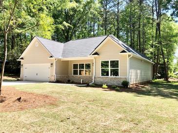 Charming new construction home with a spacious front yard at 4230 Moore Rd, Conley, GA 30288