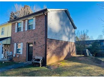Charming two-story home with brick and siding exterior, front yard, and walkway at 2711 Greystone Ct, Austell, GA 30106