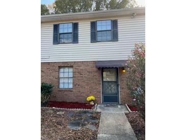 Inviting two-story home with brick and siding exterior, landscaping, and walkway at 2705 Greystone Pl, Austell, GA 30106
