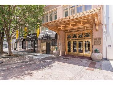 The William-Oliver Building's entrance features a grand, ornate gold awning and double doors at 32 Peachtree Nw St # 1106, Atlanta, GA 30303