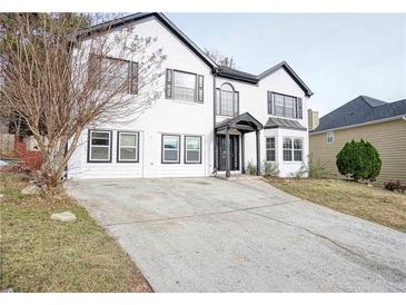 Two-story home with white brick and black accents at 2371 Shadow Pines Ct, Duluth, GA 30096