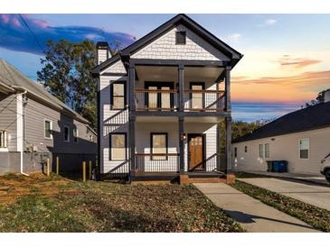 Two-story house with white siding, dark trim, and a front porch at 736 Windsor Sw St, Atlanta, GA 30310