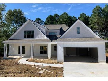 Charming two-story home with a gray and white exterior, front porch, and attached garage at 15 Stratford Way, Kingston, GA 30145