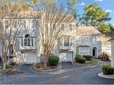 Three-unit townhome complex with attached garages and landscaping at 1532 Oak Grove Rd, Decatur, GA 30033