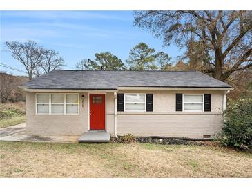 Ranch style home with red front door, black shutters, and well-maintained lawn at 2625 Abner Nw, Atlanta, GA 30318