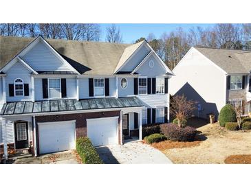 Charming two-story townhome with a two-car garage and landscaped front yard at 3723 Verde Glen Ln, Cumming, GA 30040