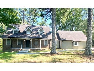 Brick ranch home with attached garage and large yard at 5940 Old Bill Cook Rd, Atlanta, GA 30349