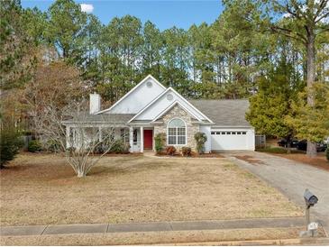 Charming one-story house with stone accents and a red door at 913 Arbor Way, Mcdonough, GA 30253
