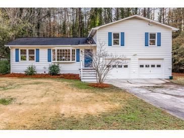 White house with blue shutters, two-car garage, and landscaped yard at 3090 Karen Ne Ln, Marietta, GA 30062