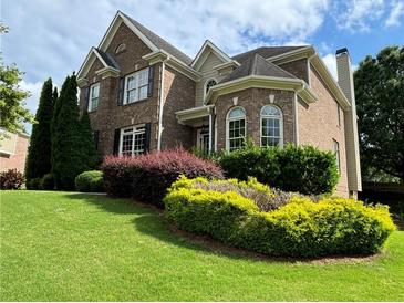 Brick two-story house with landscaped lawn at 1515 Juneau Way, Grayson, GA 30017