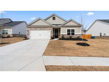 Charming two-story home with a two-car garage and landscaped yard at 3934 Saddle Bag Ct, Dacula, GA 30019