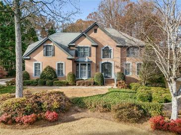 Charming brick home with landscaping and manicured lawn at 1501 Annapolis Way, Grayson, GA 30017