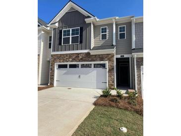 Two-story townhome with a two-car garage and landscaped yard at 1090 Cades Walk # 178, Lawrenceville, GA 30045