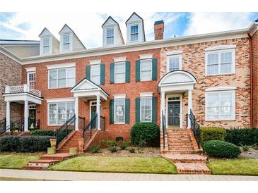 Charming brick townhome with green shutters and inviting front porch at 4754 Ivy Ridge Se Dr # 1, Atlanta, GA 30339
