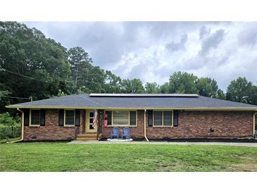 Brick ranch home with solar panels, a front porch, and a landscaped yard at 1393 Bolton Nw Rd, Atlanta, GA 30331