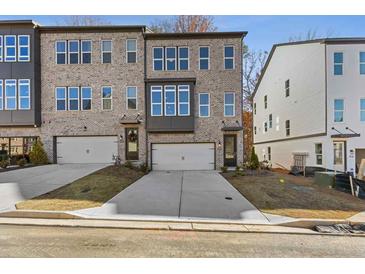 Modern two-story townhome with a brick and siding exterior, attached two-car garage at 1332 Koa Se Ct # 100, Smyrna, GA 30080