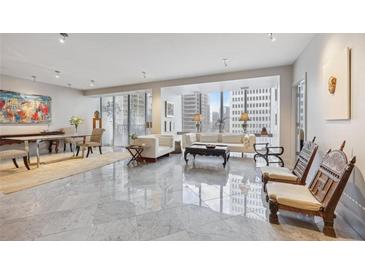 Spacious living room with marble floors, large windows, and city views at 147 15Th Ne St # 10C, Atlanta, GA 30309