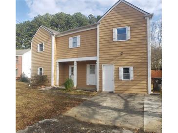 Two-story house with tan siding, white accents, and a driveway at 3962 Singletree Pl, Norcross, GA 30093