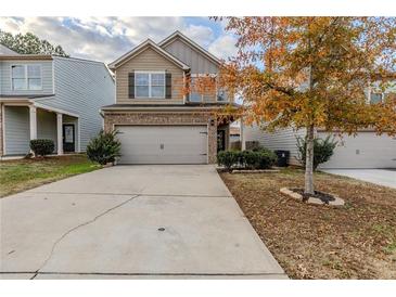 Two-story house with gray siding, two-car garage, and a landscaped yard at 5537 Union Pointe Pl, Union City, GA 30291
