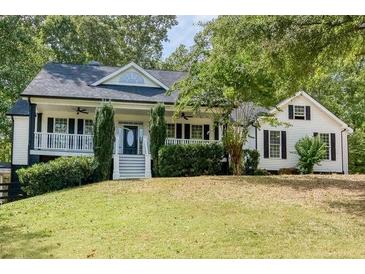 Charming two-story home with a welcoming front porch and manicured lawn at 5105 Wright Bridge Road, Cumming, GA 30028