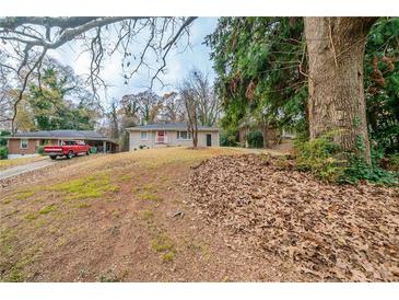 Charming single-Gathering home with a red door and a grassy front yard at 2131 Meador Se Ave, Atlanta, GA 30315