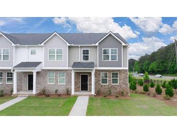 New construction home with brick and siding exterior, front yard, and walkway at 979 Cades Walk, Lawrenceville, GA 30045