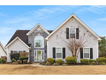 Charming two-story home with stone accents, black shutters, and a landscaped front yard at 297 Ellesmere Ct, Buford, GA 30518