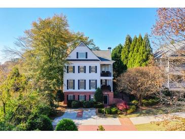 Charming white two-story home with black shutters and a brick walkway at 2111 Cooper Lake Se Rd, Smyrna, GA 30080