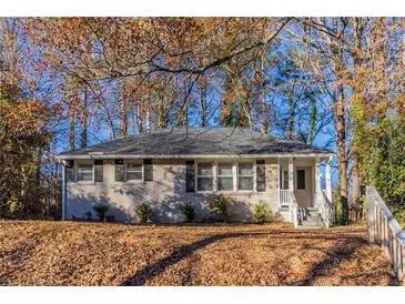 Brick ranch home with mature trees and landscaping at 1807 Oakmont Nw Dr, Atlanta, GA 30314