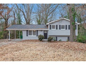 Gray house with a covered carport and a well-maintained lawn at 2625 Crestdale Se Cir, Atlanta, GA 30316