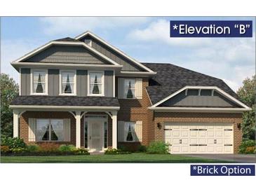 Charming two-story home with a gray and brick exterior, front porch, and attached two-car garage at 5004 Fairview Cir, Villa Rica, GA 30180