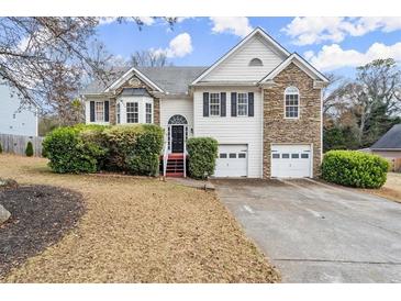 Two-story house with stone accents and a two-car garage at 1012 Inca Ln, Woodstock, GA 30188